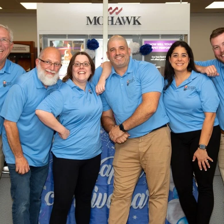 The My Dad's Flooring team posing together at their main office and showroom