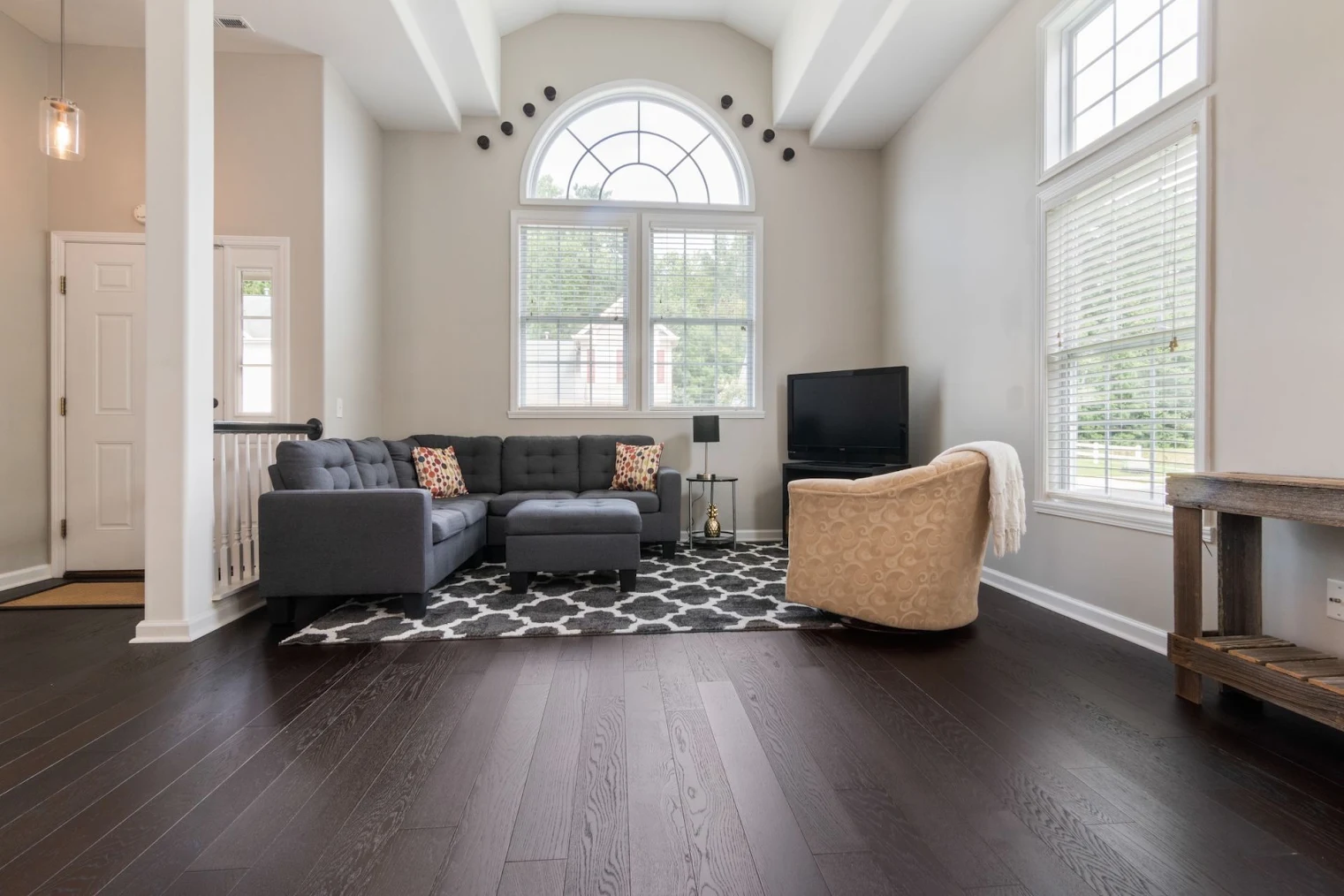 A Phoenixville living room with newly refinished engineered hardwood flooring.