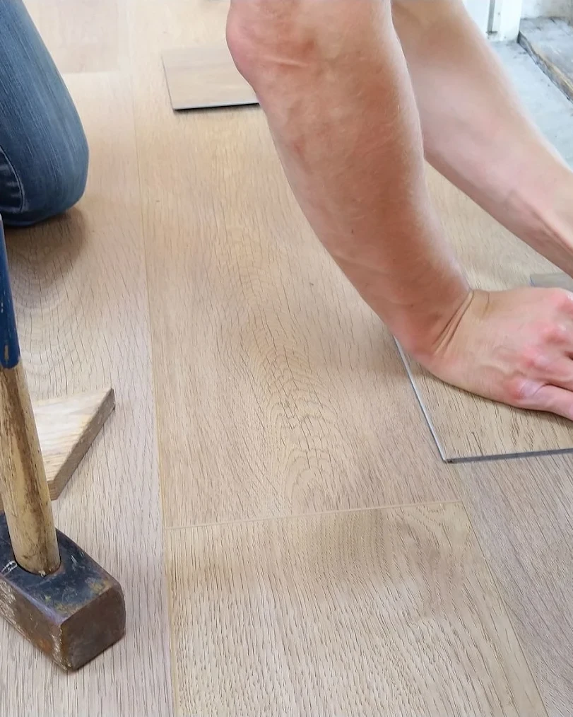A residential flooring contractor installing new flooring.